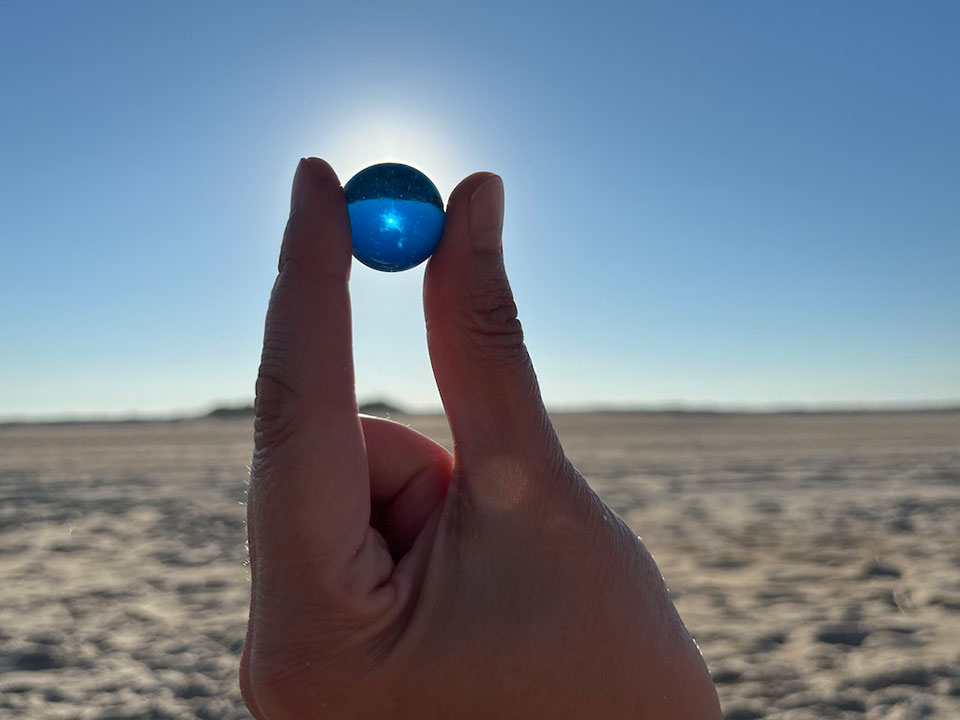 artwork depicting a marble held to the sky